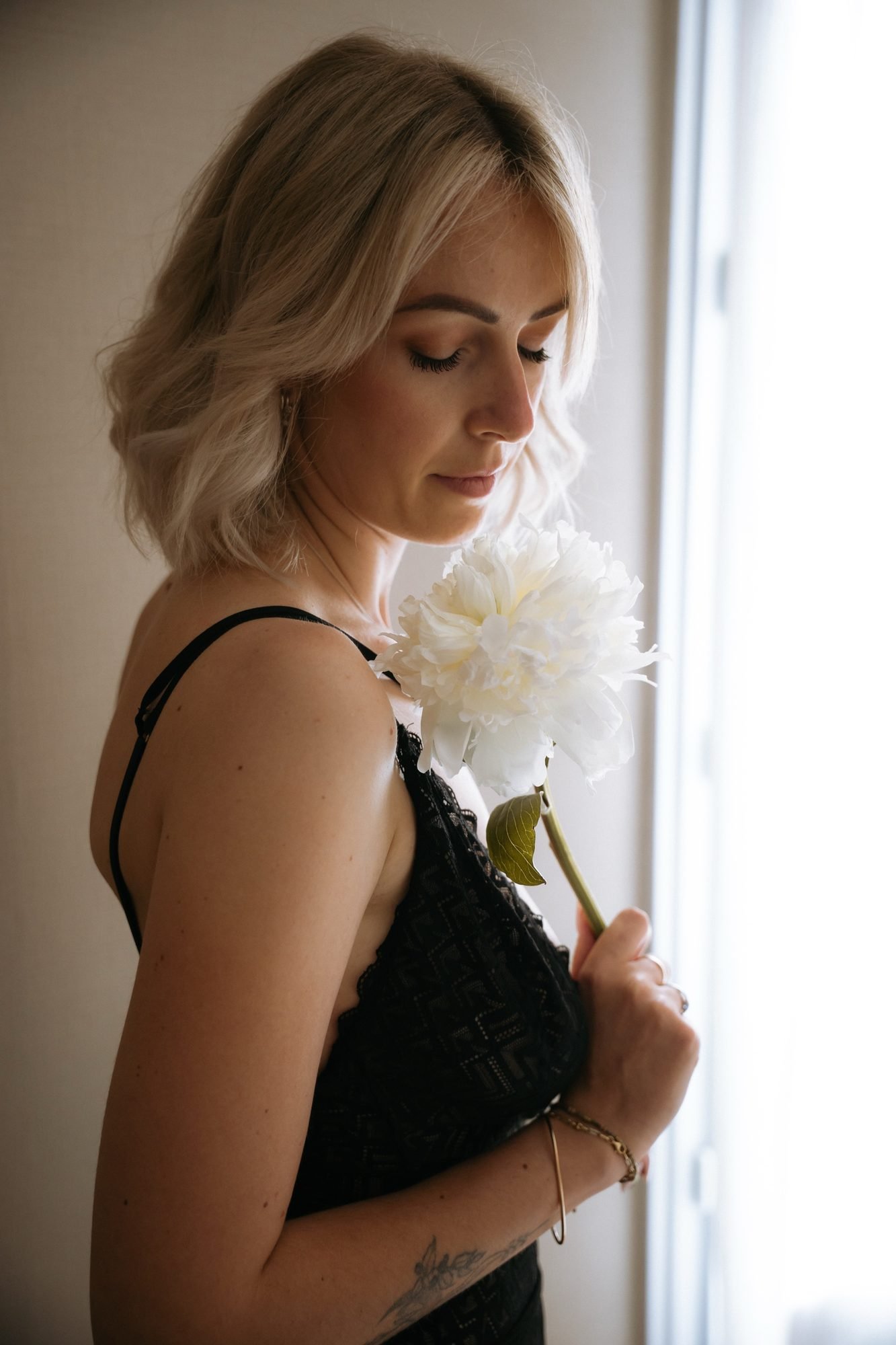 Une pivoine respirée avec douceur, dentelle noire